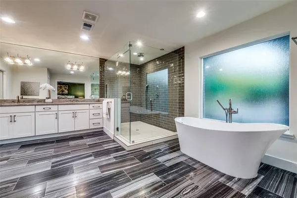 a large white room with a large mirror vanity and sink