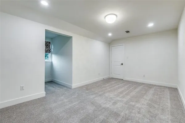 an empty room with closet and windows