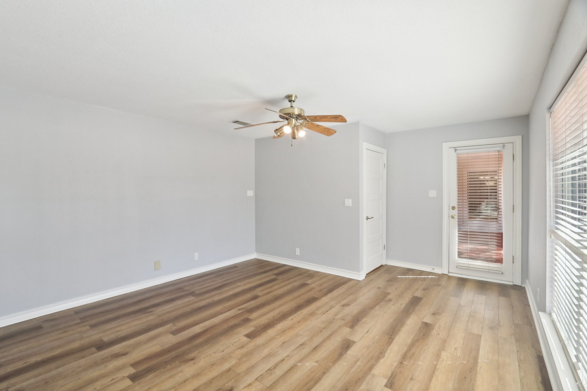 294 Logan Ranch Road Georgetown, TX 78628 - Photo 25 of 40 a view of a room with wooden floor and a ceiling fan