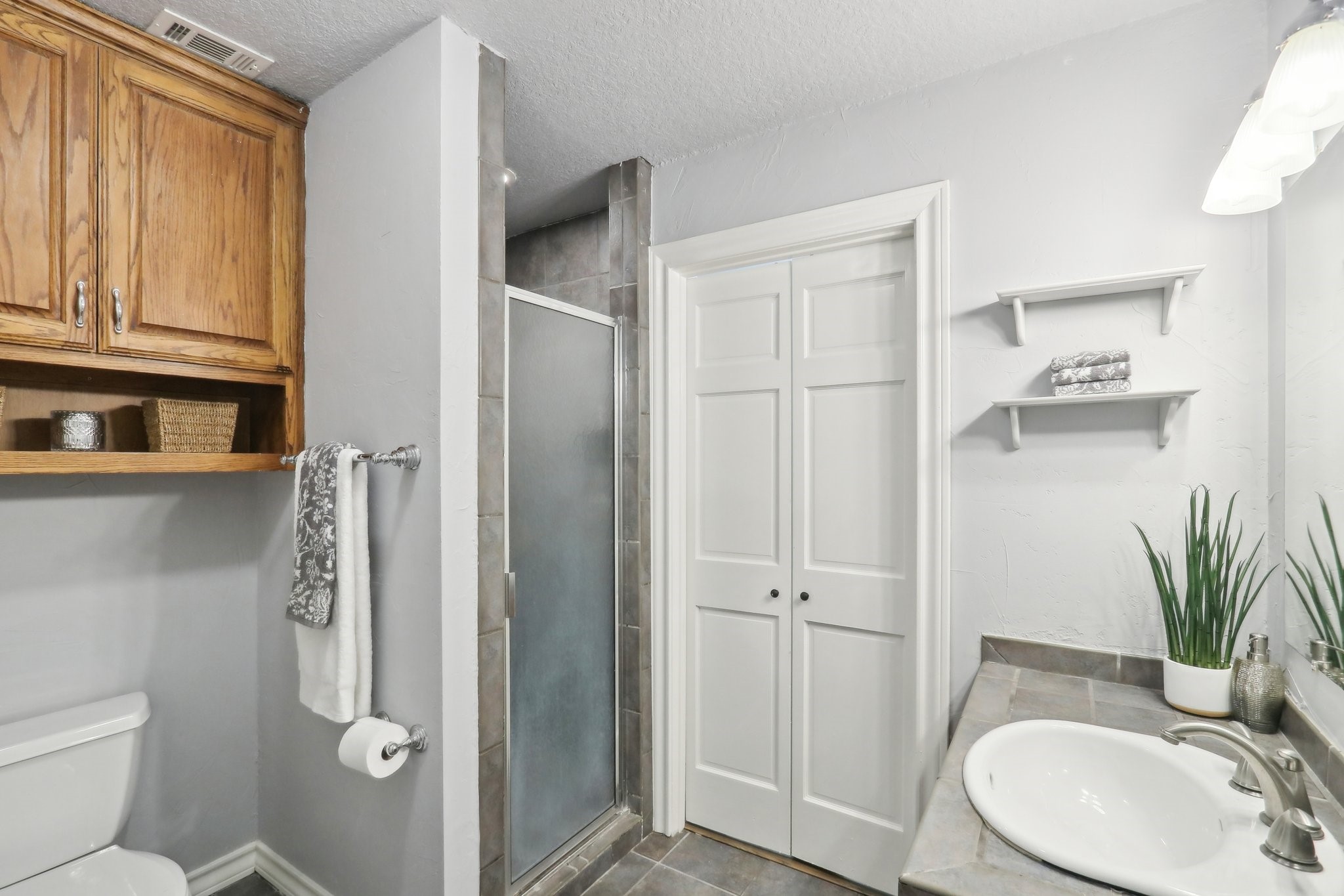 294 Logan Ranch Road Georgetown, TX 78628 - Photo 28 of 40 a bathroom with a granite countertop sink toilet and shower