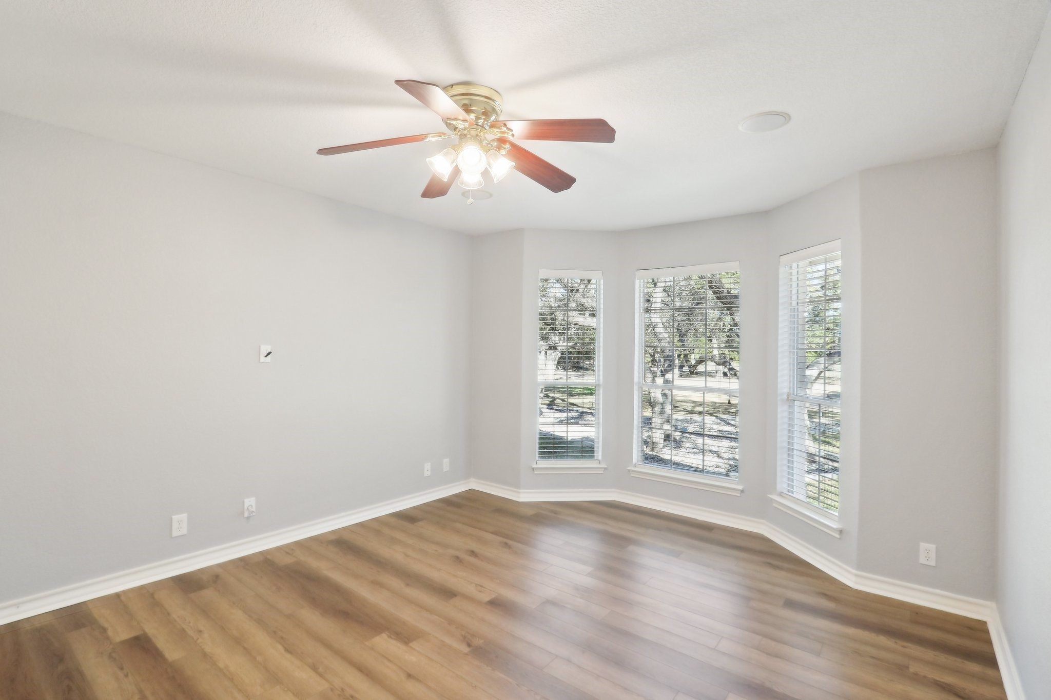 294 Logan Ranch Road Georgetown, TX 78628 - Photo 29 of 40 an empty room with wooden floor fan and windows