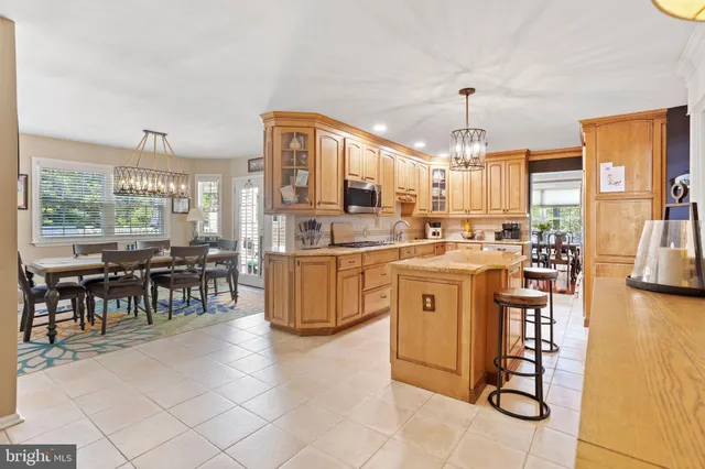 a kitchen with appliances a sink and cabinets
