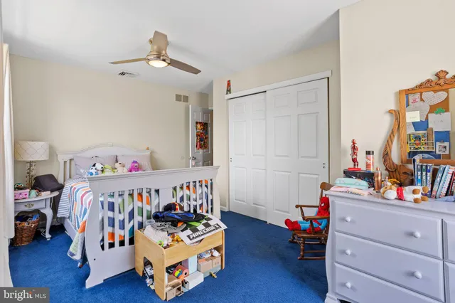 a bedroom with bed and a wooden floor