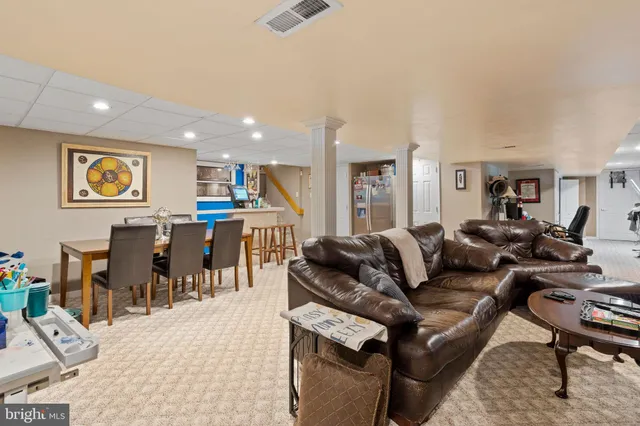 a living room with lots of furniture and a large window