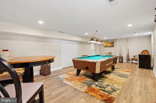 a room with furniture pool table and windows