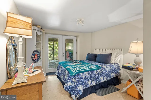 a bedroom with bed and wooden floor