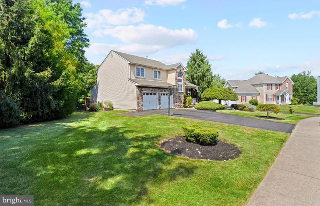 a view of a house with a swimming pool and a yard
