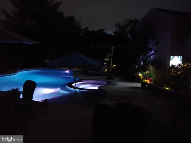 a view of a lake with lawn chairs and a big yard