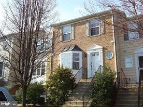 a front view of a house with trees