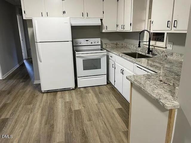 7 Noble Road Franklinton, NC 27525 - Photo 3 of 8 a kitchen with granite countertop white cabinets and white appliances
