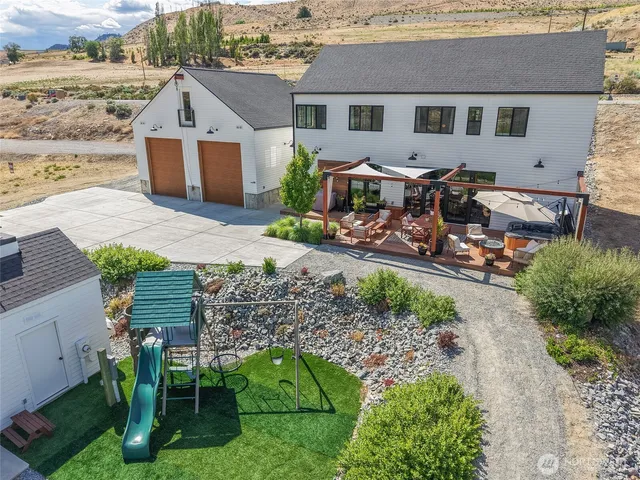 an aerial view of a house with a yard table and chairs