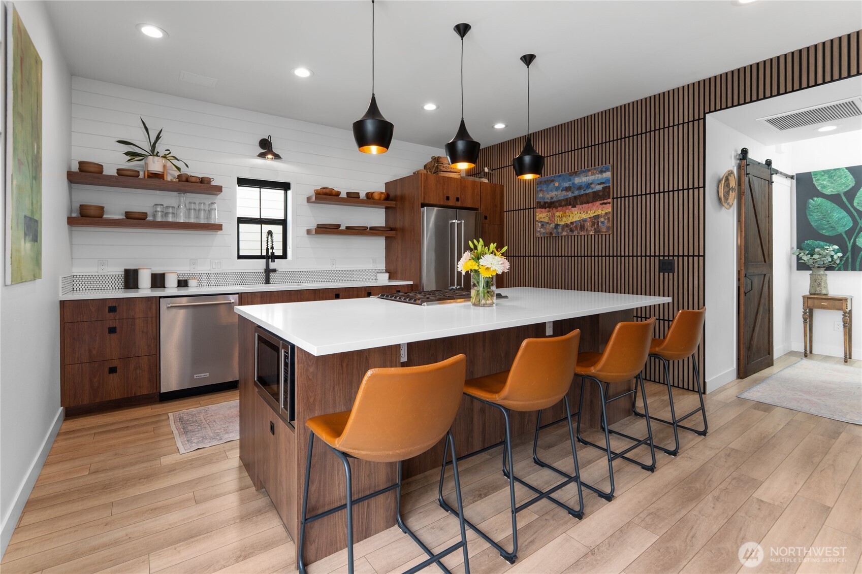 485 Hidden Lane Chelan, WA 98816 - Photo 6 of 40 a kitchen with granite countertop a table chairs sink and wooden floor