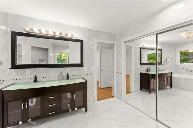 a spacious bathroom with a double vanity sink and a mirror
