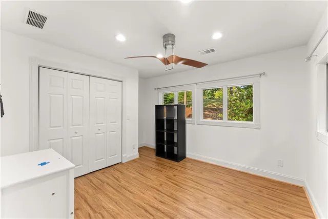 a bedroom with a bed and wooden floor