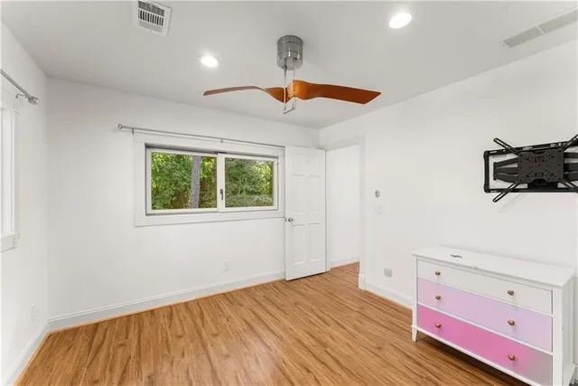 a bathroom with a sink a toilet and a window