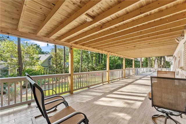 a view of balcony with wooden floor and outdoor seating