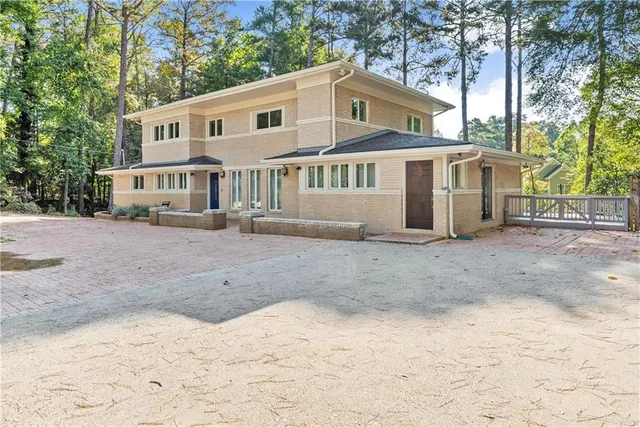 a front view of a house with a yard covered in snow