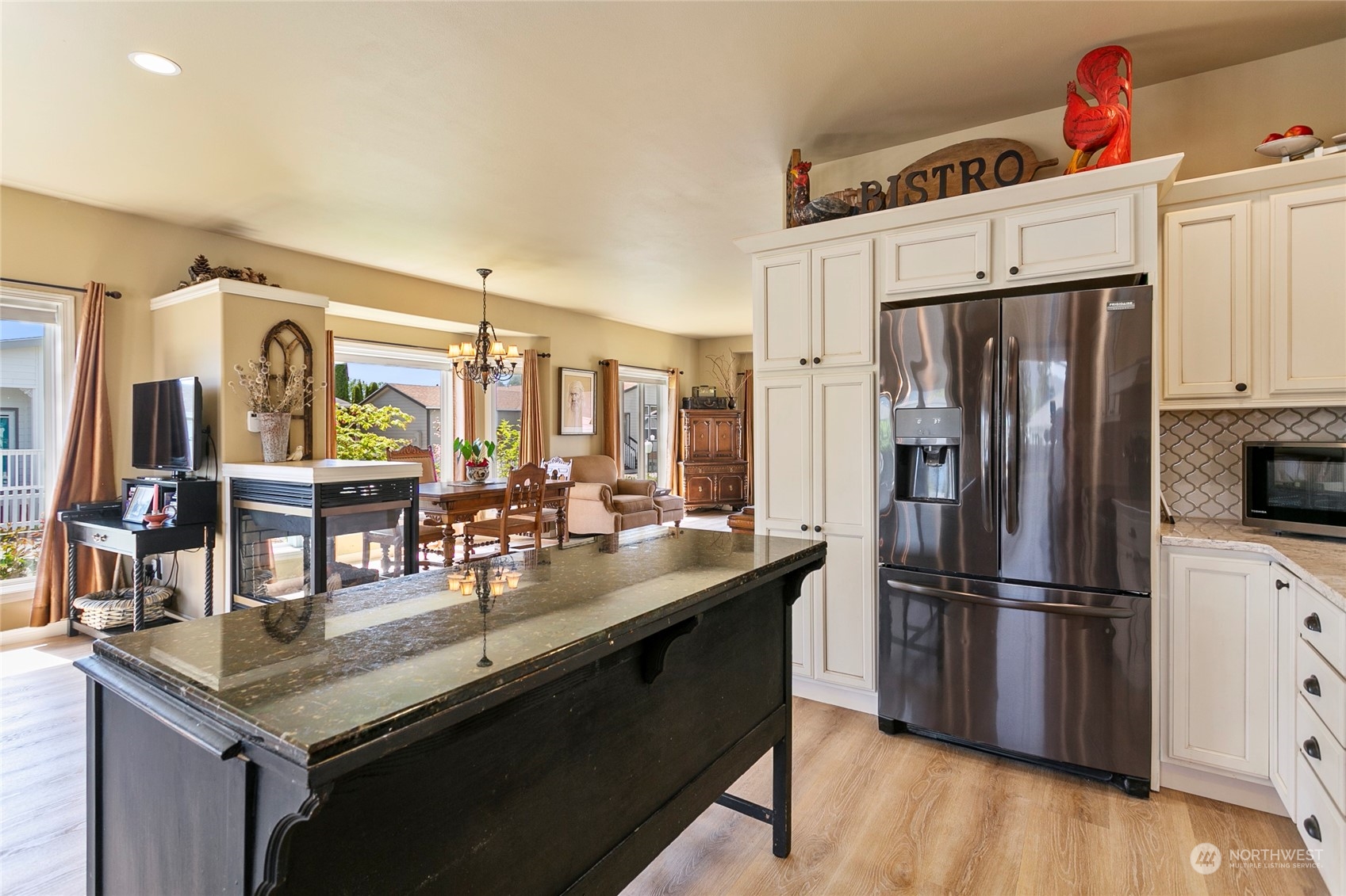 107 South Pass Road, Unit 32 Nooksack, WA 98276 - Photo 21 of 40 a kitchen with granite countertop a refrigerator a stove and a wooden floor