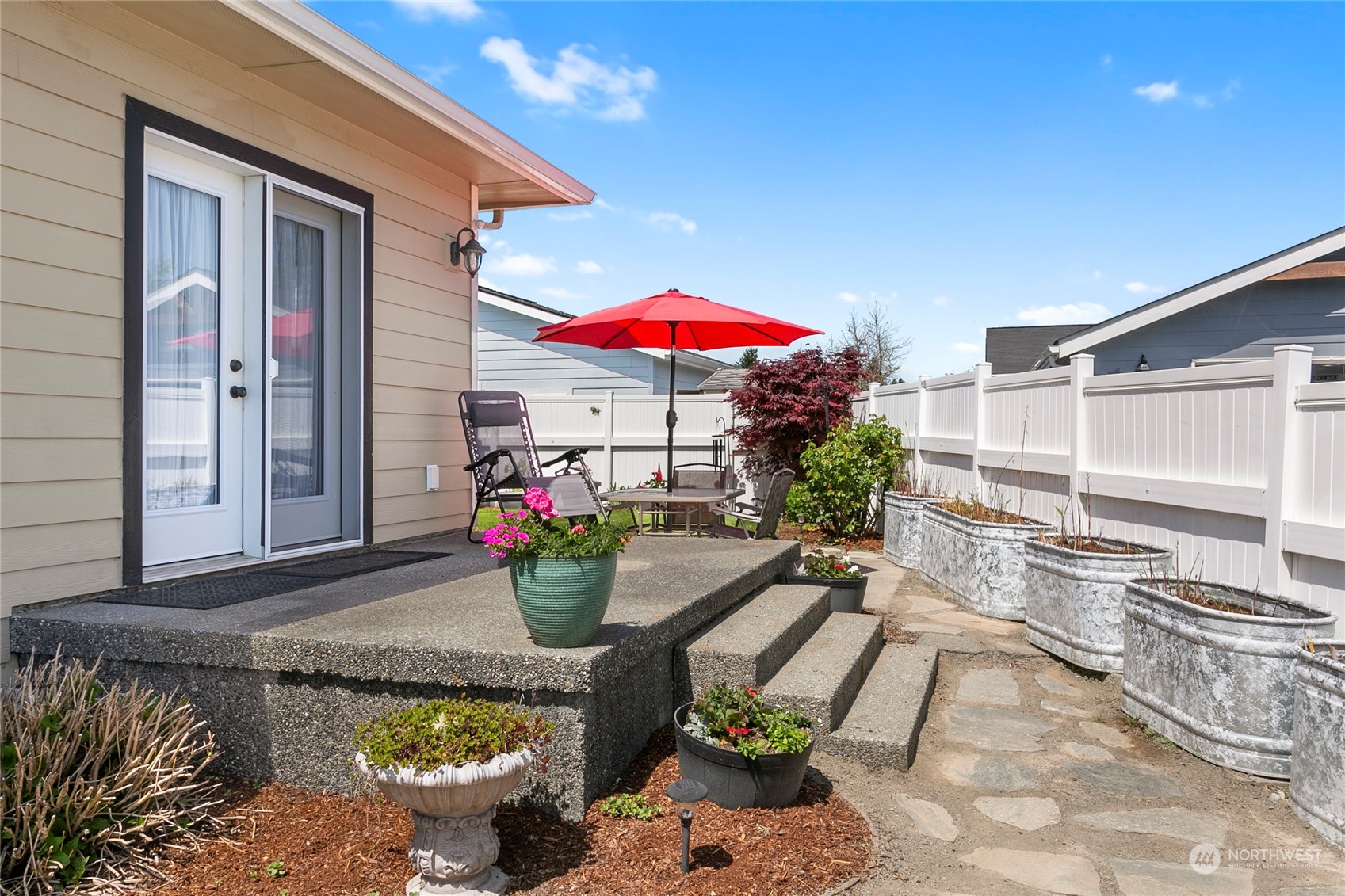 107 South Pass Road, Unit 32 Nooksack, WA 98276 - Photo 35 of 40 a view of a patio with table and chairs potted plants