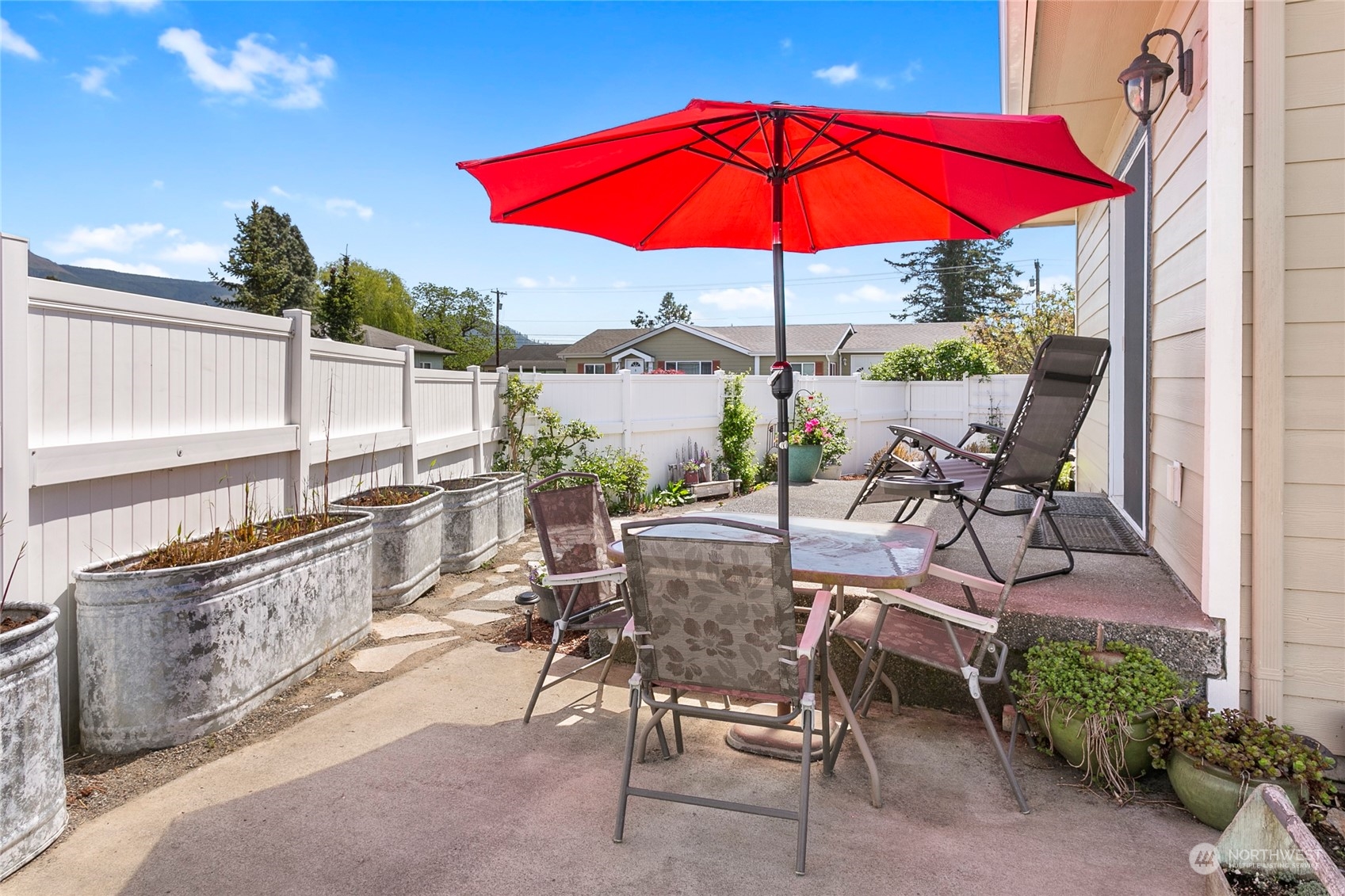 107 South Pass Road, Unit 32 Nooksack, WA 98276 - Photo 36 of 40 a view of a patio with chairs under an umbrella