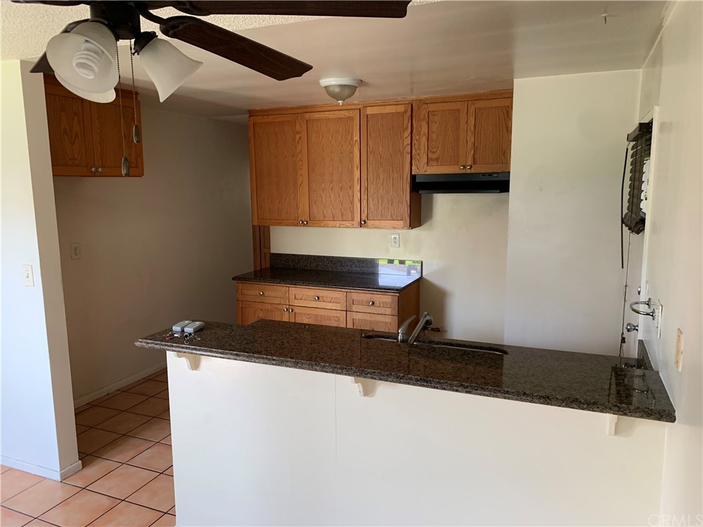 9713 Cedar Street Bellflower, CA 90706 - Photo 3 of 5 a kitchen with a refrigerator and a stove top oven