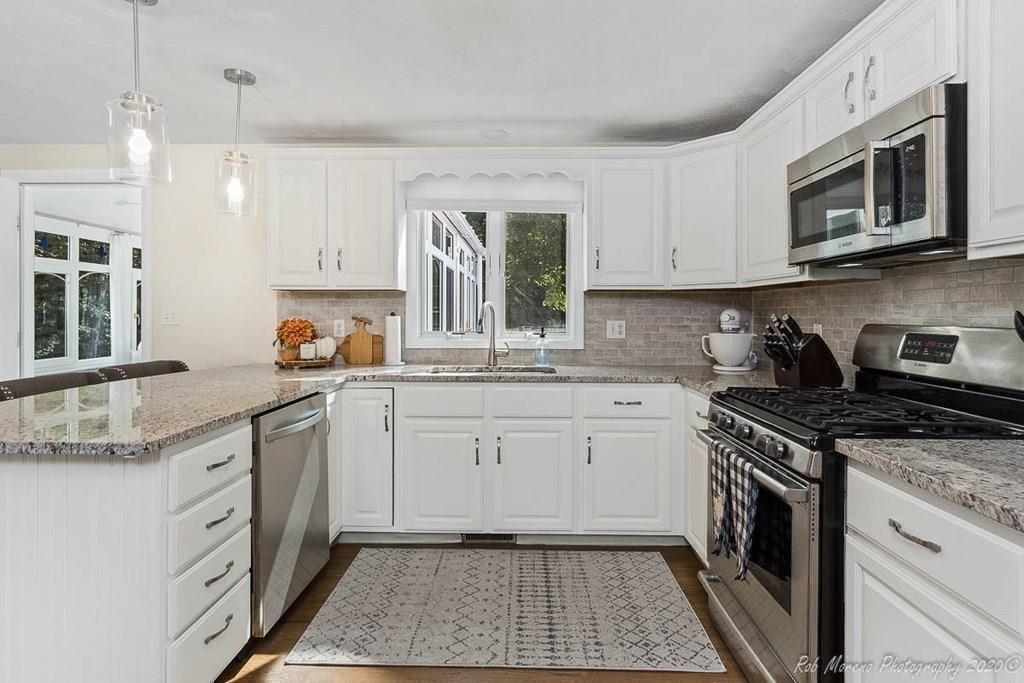 324 Linebrook Road Ipswich, MA 01938 - Photo 11 of 39 a kitchen with a sink stove and microwave