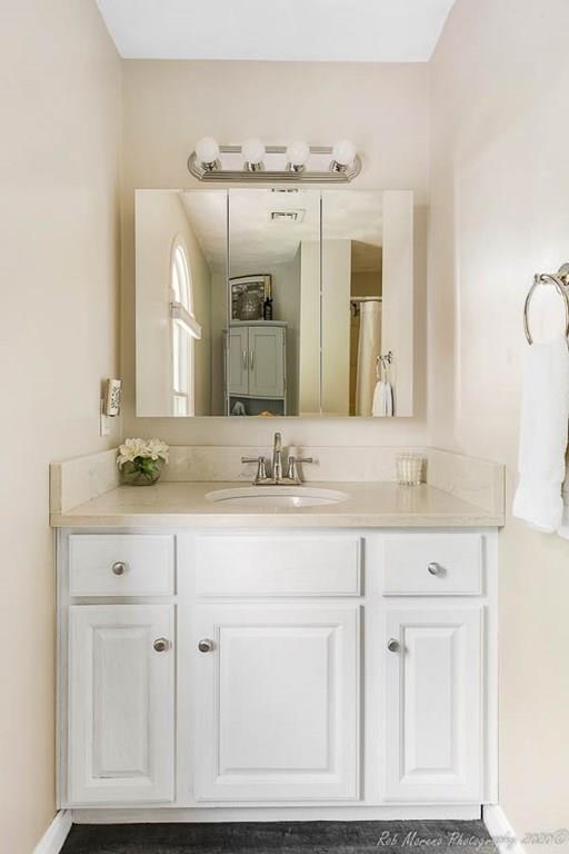 324 Linebrook Road Ipswich, MA 01938 - Photo 27 of 39 a bathroom with a sink vanity and mirror