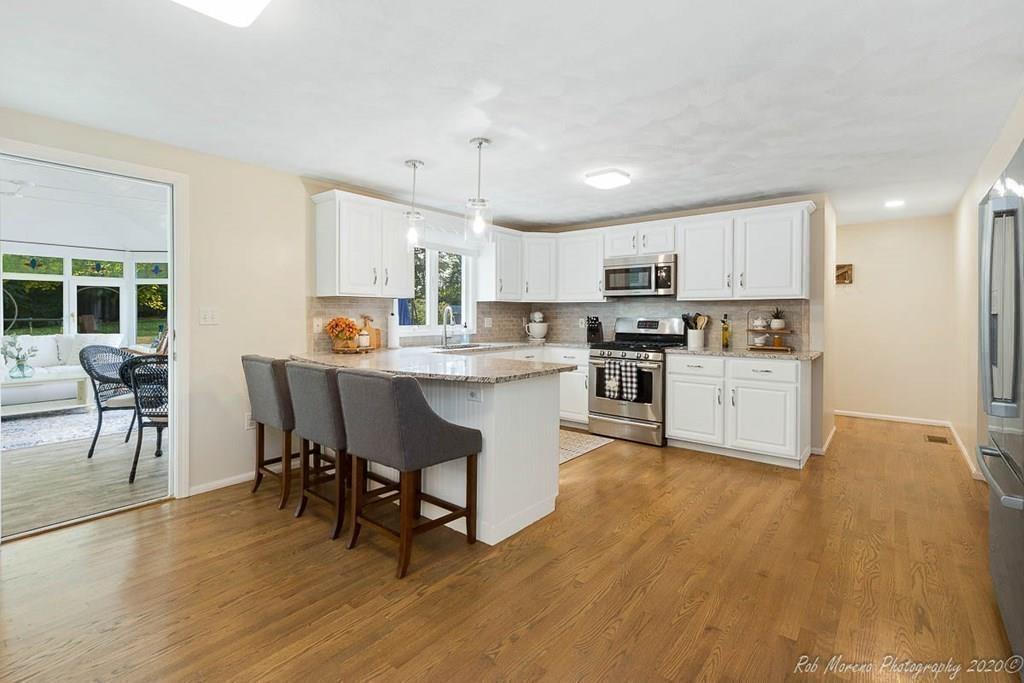 324 Linebrook Road Ipswich, MA 01938 - Photo 10 of 39 a kitchen with kitchen island a dining table and chairs