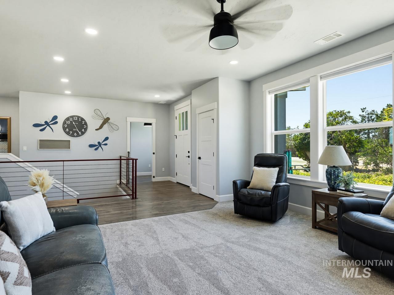 4950 West Columbia Road Nampa, ID 83687 - Photo 9 of 50 Open concept common area featuring large windows, recessed lighting, and a modern ceiling fan