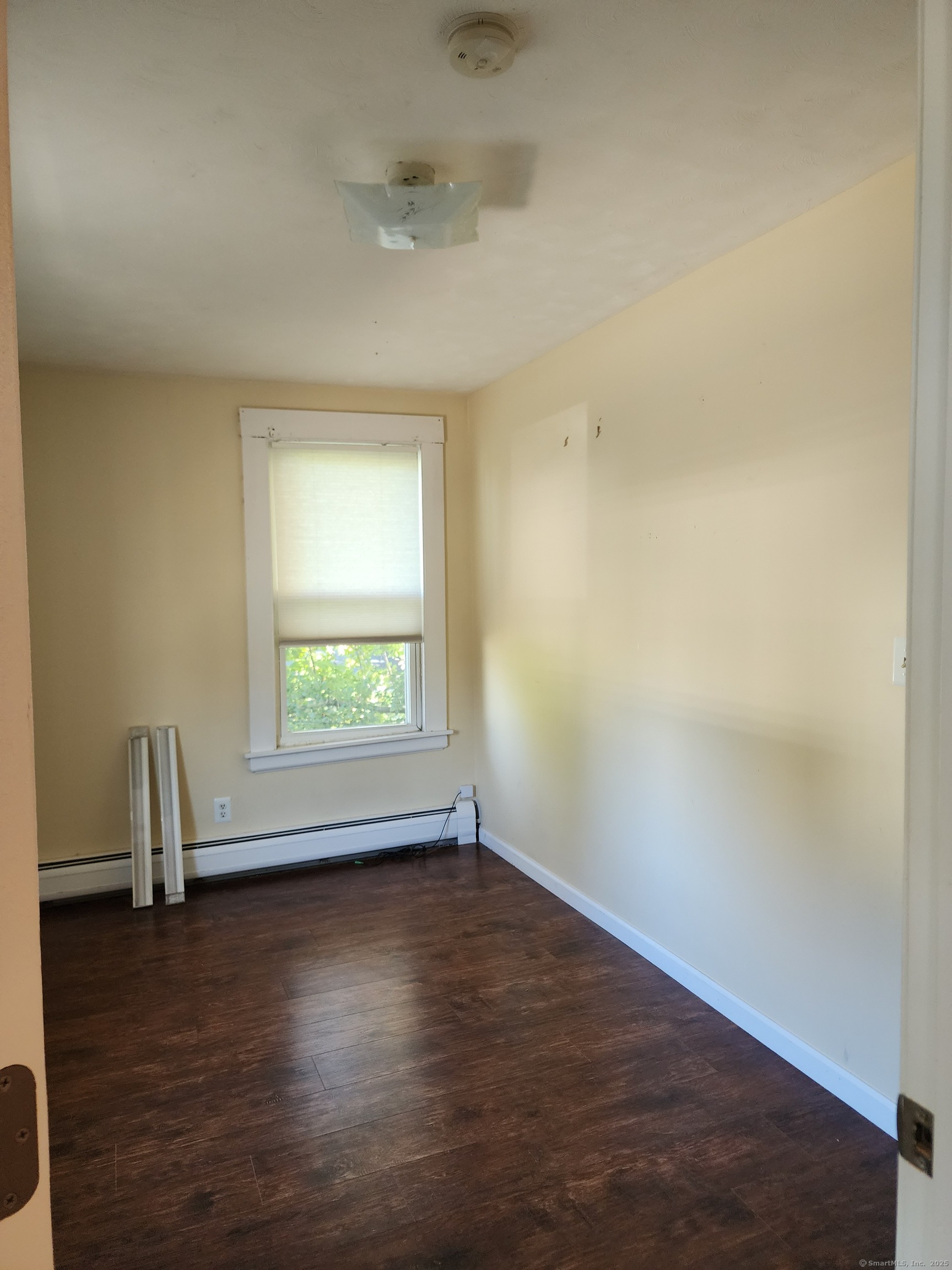 136 Broad Street Plainville, CT 06062 - Photo 5 of 10 an empty room with wooden floor and windows