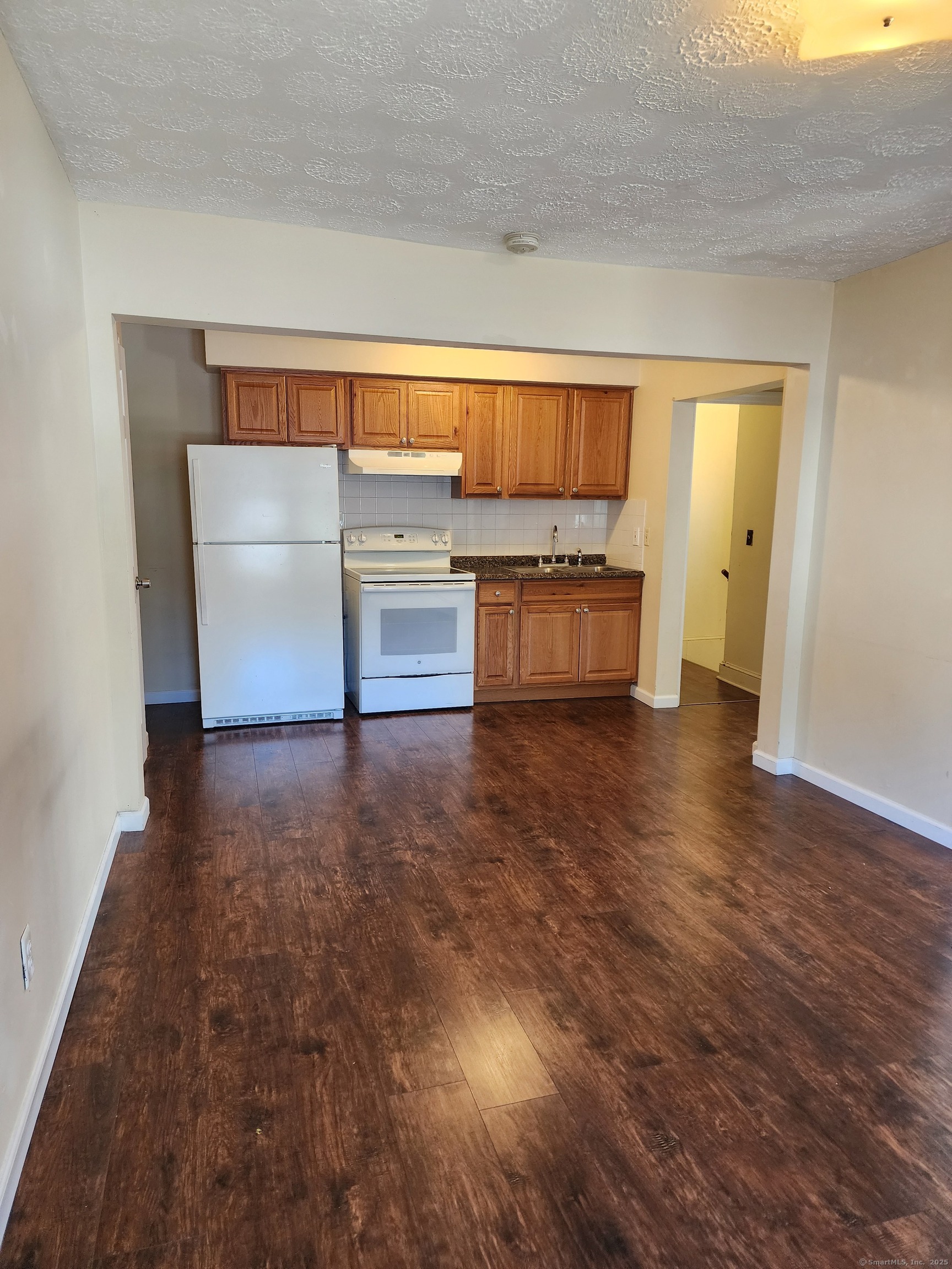 136 Broad Street Plainville, CT 06062 - Photo 6 of 10 a living room with furniture and a fireplace