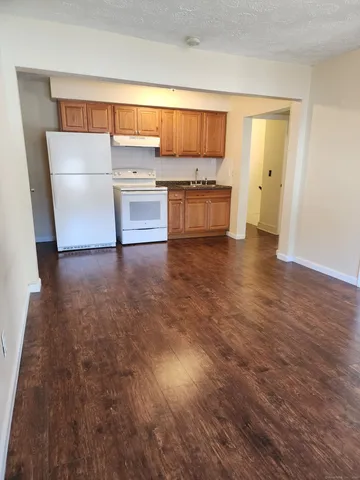 a view of a kitchen with a sink and a refrigerator