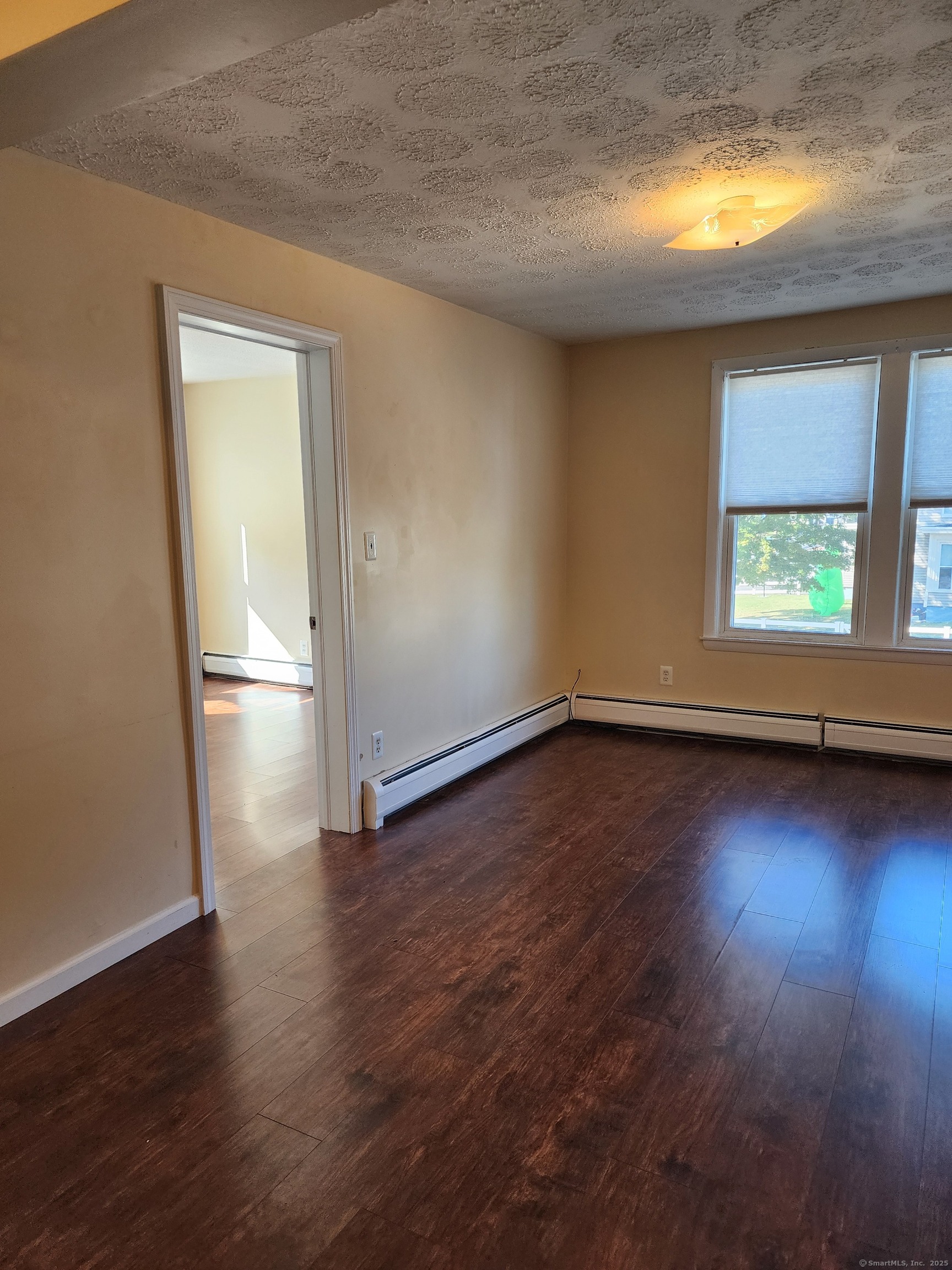 136 Broad Street Plainville, CT 06062 - Photo 8 of 10 an empty room with wooden floor and windows