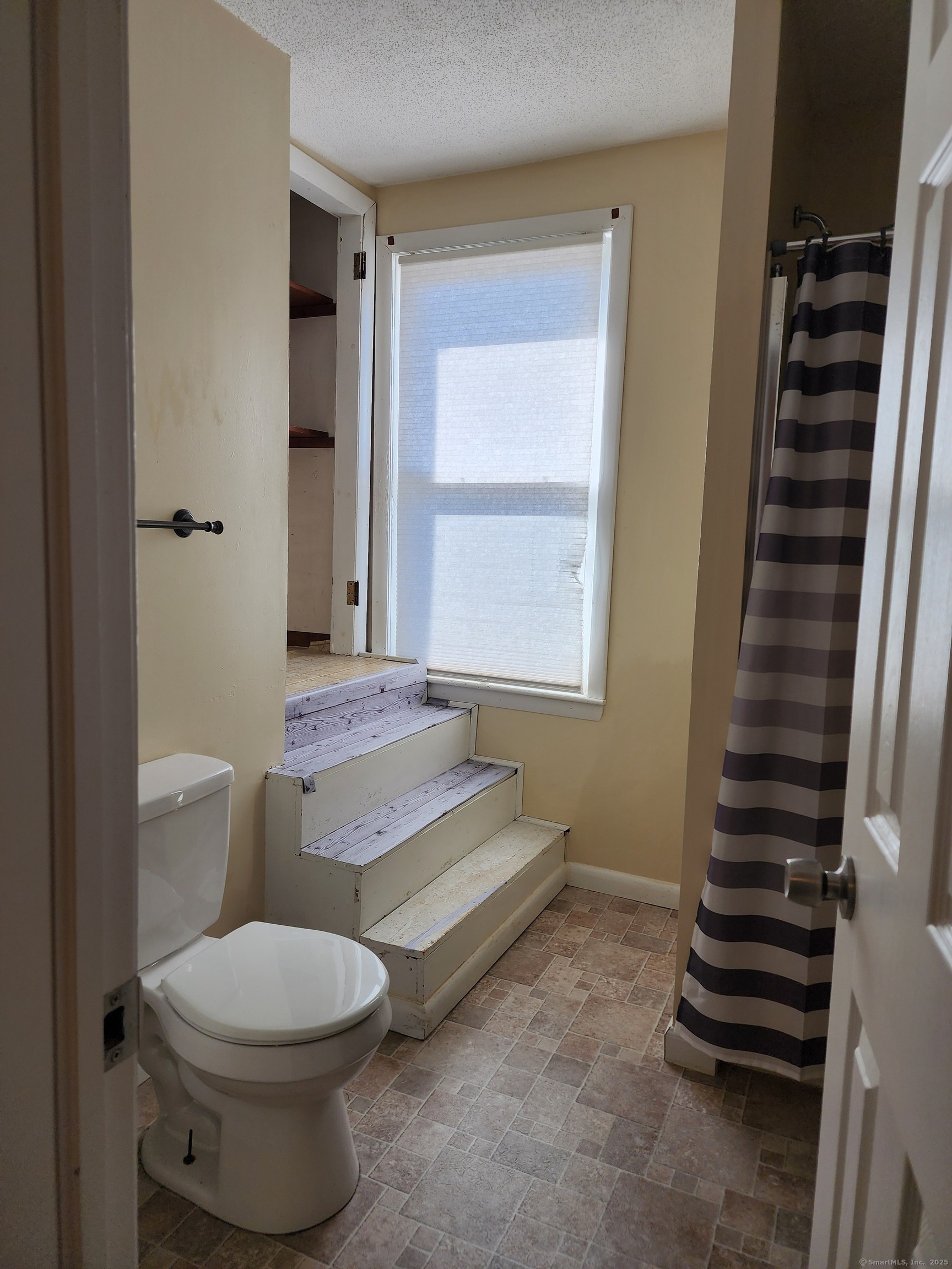 136 Broad Street Plainville, CT 06062 - Photo 9 of 10 a bathroom with a toilet a sink and a window