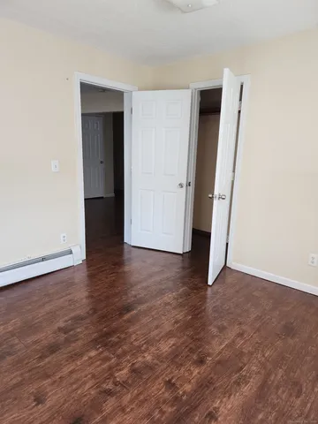 an empty room with wooden floor and closet