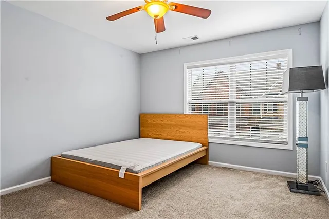 a bathroom with a granite countertop sink toilet mirror vanity and shower