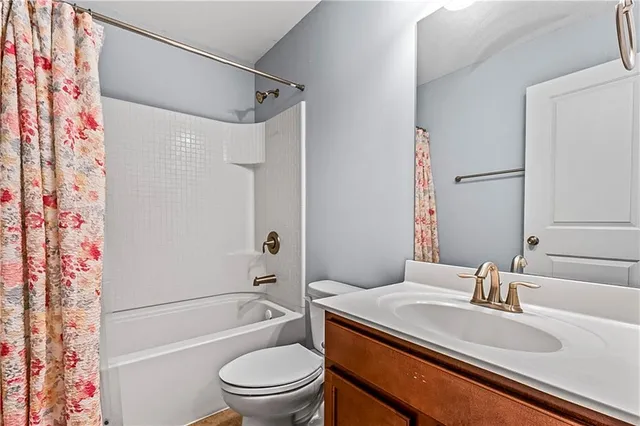 an empty room with windows and ceiling fan