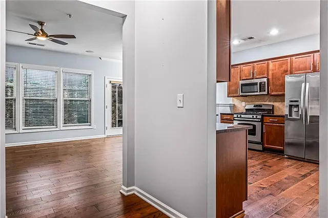 a view of an empty room with a fireplace and window