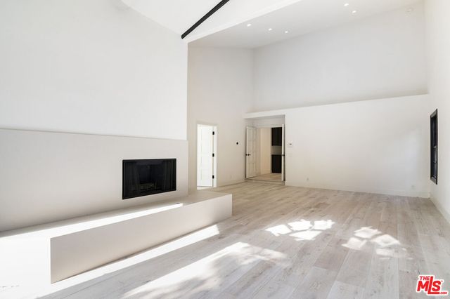 a view of an empty room with a fireplace