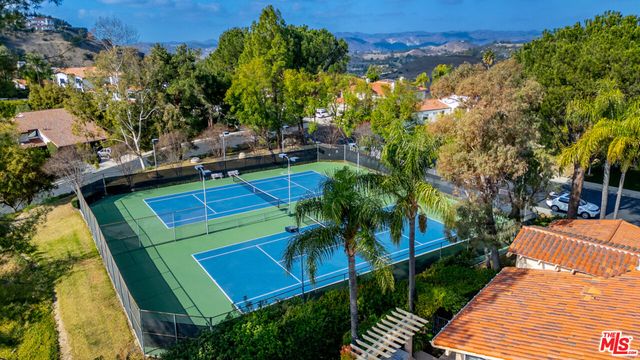 a view of a backyard with plants and a patio