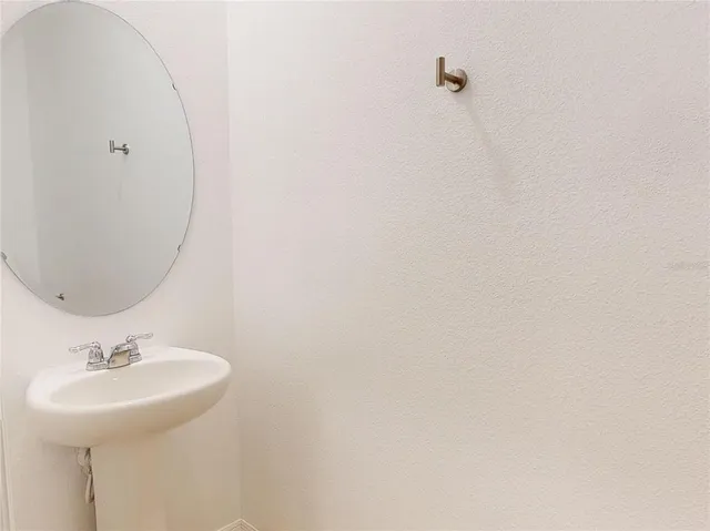 a bathroom with a sink and mirror