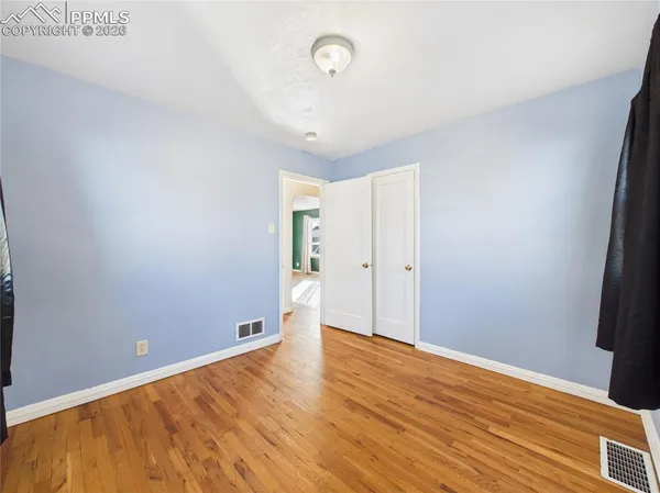a view of room with wooden floor