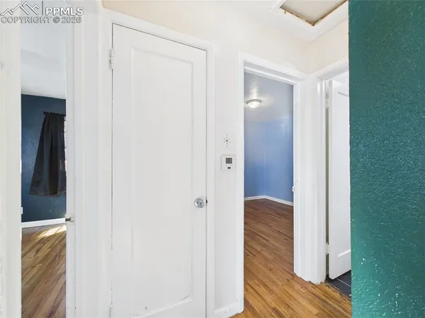 a view of hallway with wooden floor