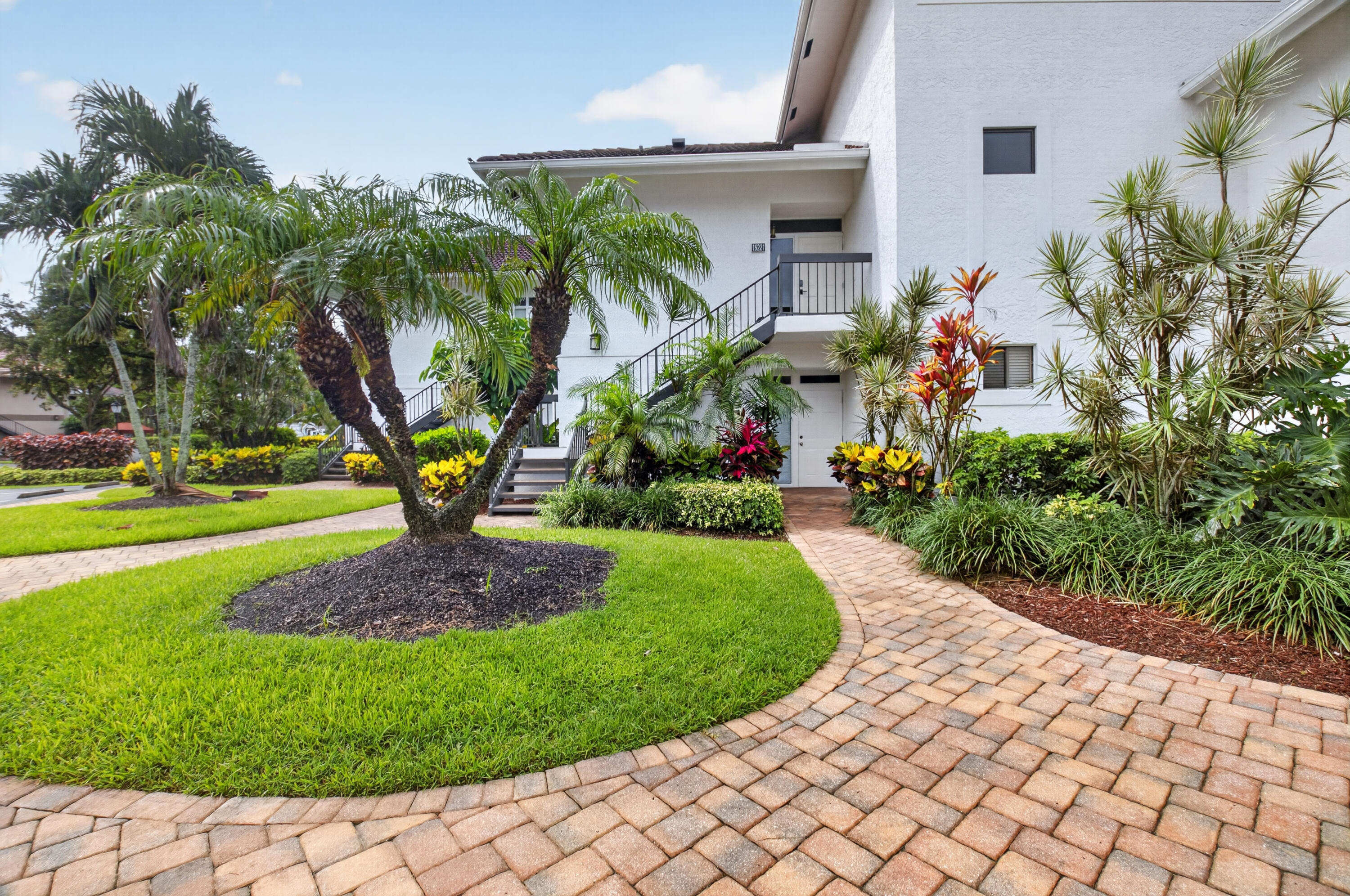 19221 Sabal Lake Drive, Unit 5124 Boca Raton, FL 33434 - Photo 2 of 98 a front view of a house with a yard