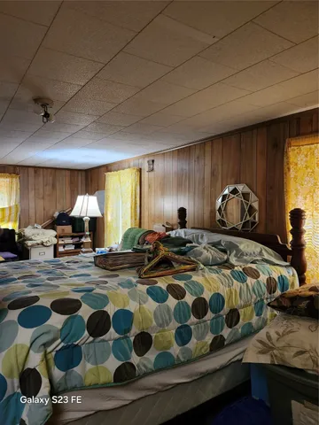 a bedroom with bed and a window