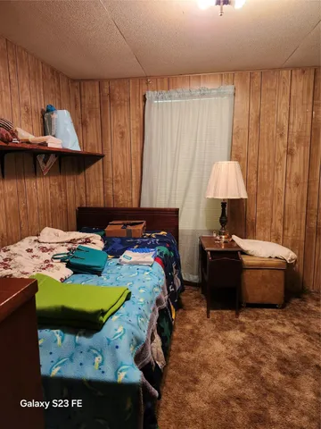 a bed sitting in a bedroom next to a window