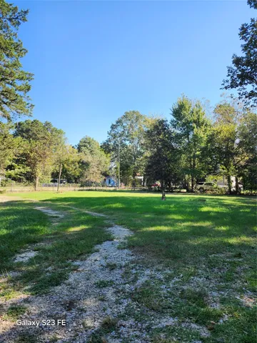 a view of field with trees in the background