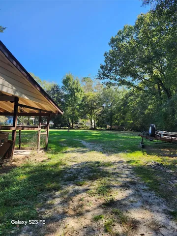 a view of a swimming pool with a yard