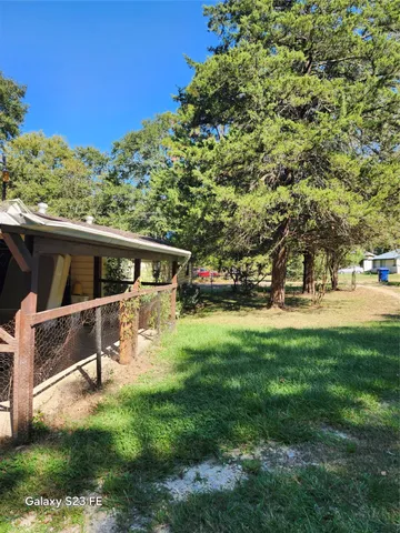 a view of an house with backyard space and sitting area