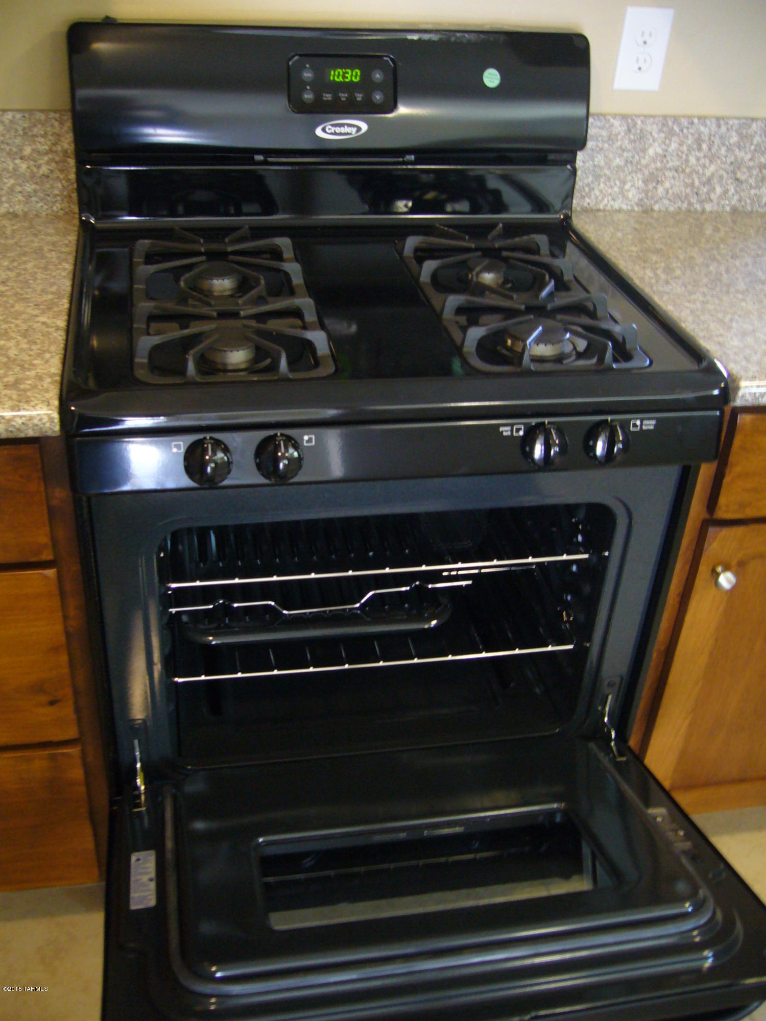 1243 West Kleindale Road Tucson, AZ 85705 - Photo 15 of 46 a stove top oven sitting inside of a kitchen